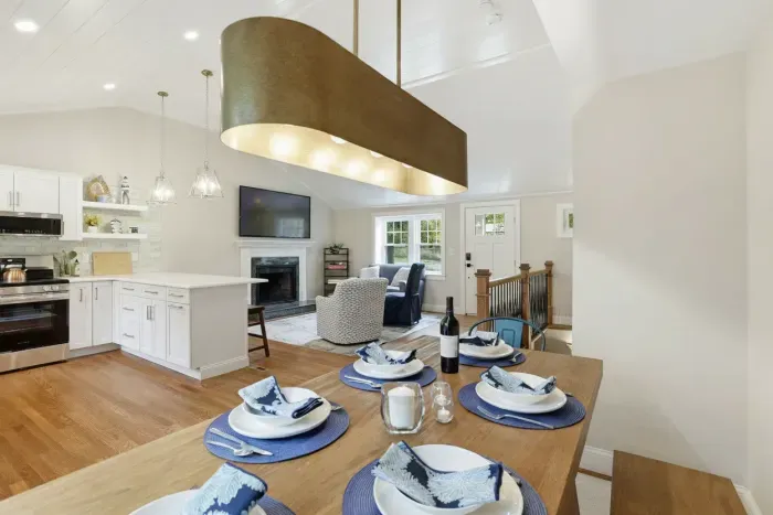 Bright open-concept kitchen, dining & living space with fireplace