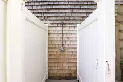 Private outdoor shower with coastal charm and tall privacy fencing