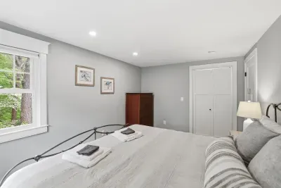 Bright, cozy bedroom with wooded views and a spacious, restful feel