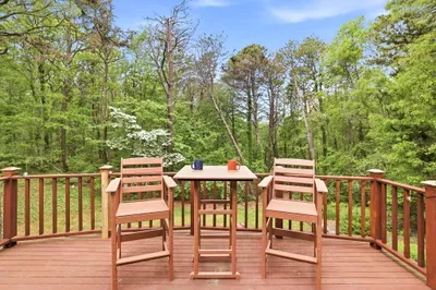 Peaceful wooded deck with café seating for relaxing outdoor moments