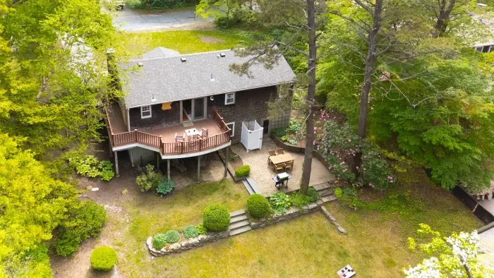 Secluded wooded retreat with elevated deck, patio, and peaceful outdoor space