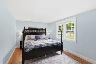 Bright, serene bedroom with four-poster bed and abundant natural light