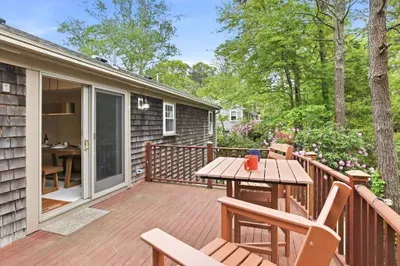 Private wooded deck with outdoor dining and peaceful garden views