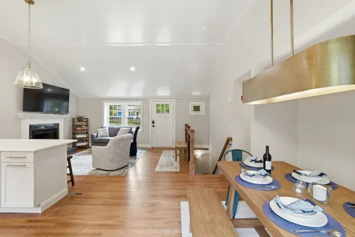 Bright open-concept living with cozy fireplace and stylish dining area