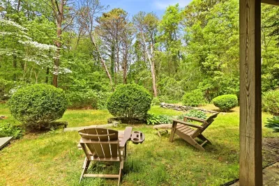 Private backyard retreat with Adirondack seating and wooded views