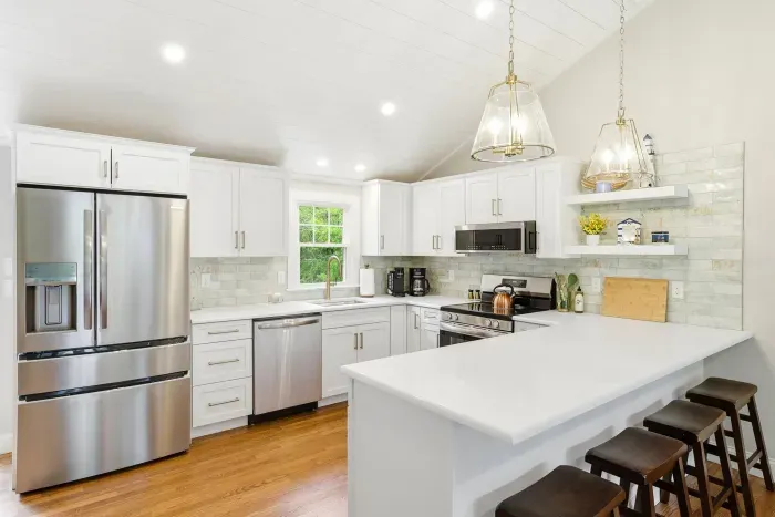 Bright modern kitchen with large island seating and stainless appliances