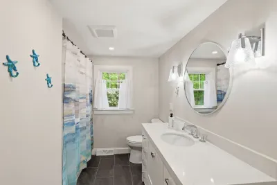 Bright coastal bathroom with modern vanity, natural light, and fresh finishes