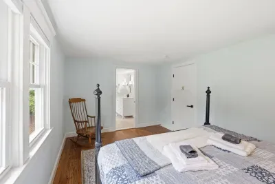 Bright, airy bedroom with four-poster bed and natural light
