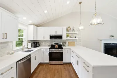 Bright vaulted kitchen with quartz counters and stylish pendant lighting