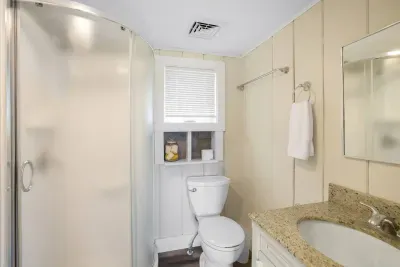 Essentials like individual shampoo, hand towel, conditioner, and a soap bar are all provided.