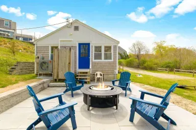 Step outside to discover the outdoor shower, a cozy fire pit, and ample outdoor furniture for relaxing.