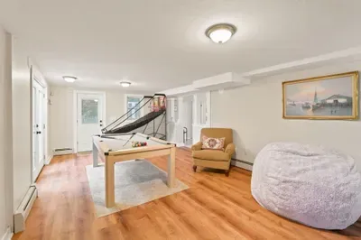 Fun game room with pool table, basketball shootout, and cozy lounge seating