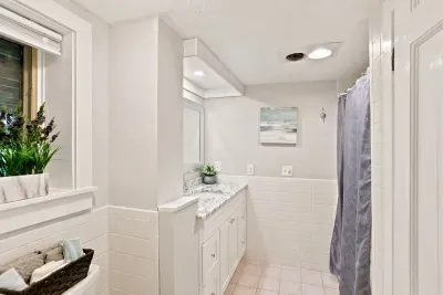 Bright bathroom with granite vanity, natural light, and clean modern style