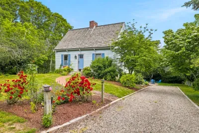 Charming cottage with lush gardens, private drive, and storybook curb appeal