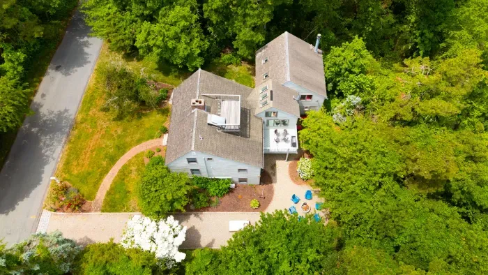Secluded wooded retreat with landscaped grounds and inviting outdoor spaces