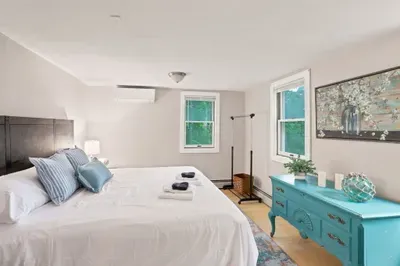 Bright, cozy bedroom with king bed, AC, and charming vintage touches