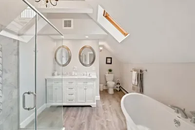 Spa-like bathroom with soaking tub, skylight, and glass walk-in shower