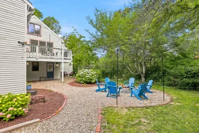 Private backyard retreat with deck and Adirondack fire pit seating