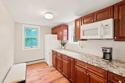 Bright updated kitchen with granite counters, full appliances & coffee station
