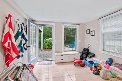 Bright family-friendly mudroom with yard access and beach gear storage