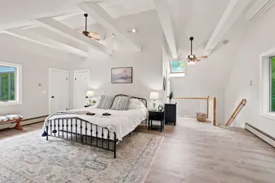 Airy king bedroom with vaulted ceilings and serene loft-style charm