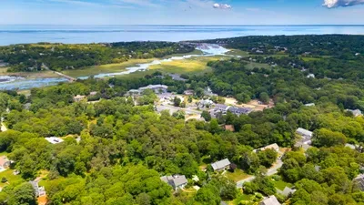 Aerial view of a serene coastal neighborhood near marshes and beach