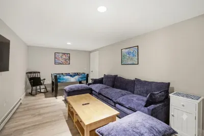 Unwind in a sanctuary of crisp, modern design. Sink into the cloud-like comfort of the oversized sectional, let the bright natural light refresh you, and queue up your favorite movie for an evening of pure, uninterrupted relaxation.