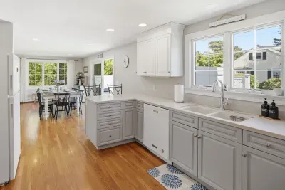 Bright open kitchen with sunny dining area and hardwood floors