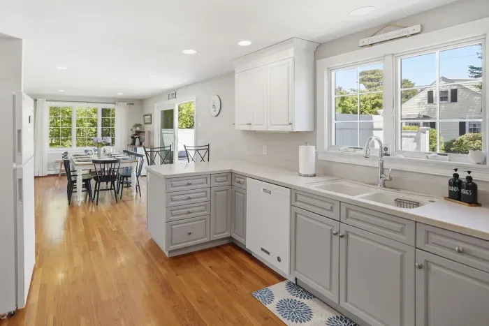 Bright open kitchen with sunny dining area and hardwood floors