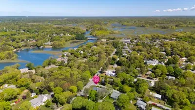 Aerial view of tree-lined neighborhood near scenic waterways
