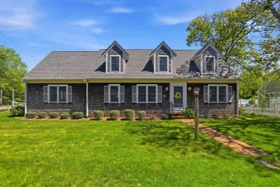Love at first sight. With its timeless Cape Cod architecture and beautifully manicured green grass, this charming facade delivers an instant, warm hug before you even step through the front door.