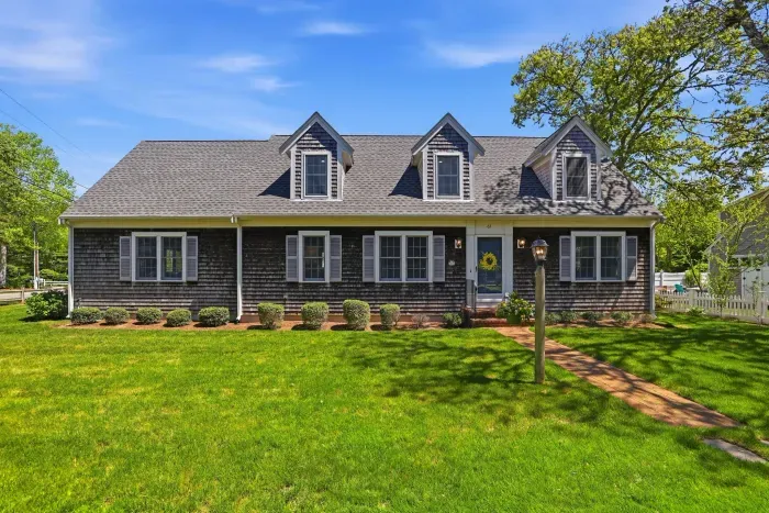 Love at first sight. With its timeless Cape Cod architecture and beautifully manicured green grass, this charming facade delivers an instant, warm hug before you even step through the front door.