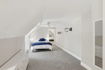 Wake up tucked beneath the eaves, where soft coastal light kisses the room. Sink your toes into the cloud-like, plush carpet, breathe in the breezy seaside vibes, and let the outside world fade away in your private rooftop nest.