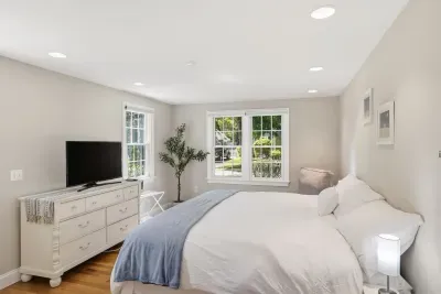 Your peaceful haven awaits. Unwind in a bright, tranquil space designed for deep sleep, complete with a TV for cozy movie nights and seamless, just-steps-away bathroom access.