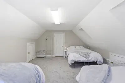 Nestled right under the roofline, this sun-drenched sanctuary is pure comfort. With plenty of room for everyone to drift off together, it’s a space built for late-night whispers, giggles, and sweet dreams.