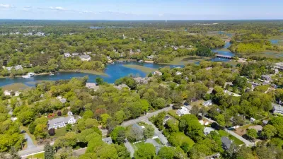 A bird's-eye view of pure tranquility. See how the lush green canopy gently meets the endless, winding blue? This is the peaceful, water-rimmed paradise waiting right outside your door.