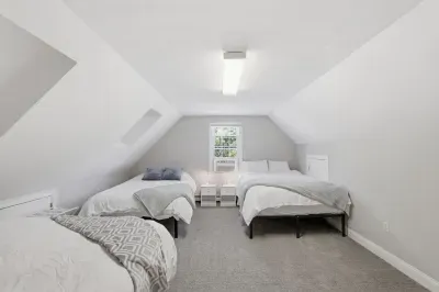 Sleeping among the clouds. This sun-drenched, airy loft captures the ultimate vacation vibe, offering a beautifully designed architectural hideaway where friends or family can drift off together under the high ceilings.