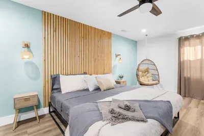 Basement master bedroom with hanging egg chair and makeup vanity all within the convenience of your own room!