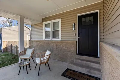 Additional photo of covered front porch sitting area.