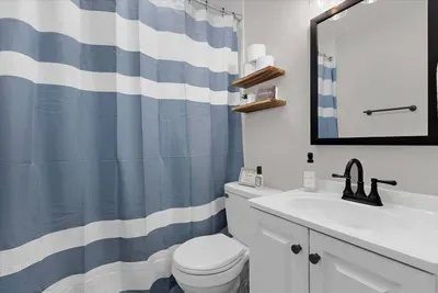 Full bathroom with a tub/shower combination in the upstairs hallway equipped with body wash, shampoo, conditioner, Poo-Pourri, hand soap, Q-Tips, etc.