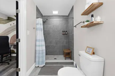 Enjoy the convenience and privacy of the master bedroom bathroom with custom walk-in shower.