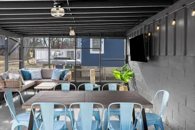 You'll love the screened in outdoor room equipped with plenty of seating, outdoor TV, string lights, and a comfy hanging egg chair perfect for a slow morning or cozy evening in!