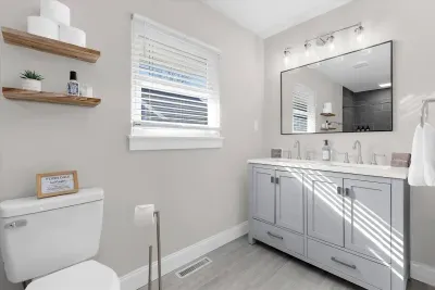 Master bathroom with custom tile walk in shower and double vanity.