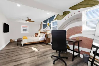Large, comfortable master bedroom with king size mattress, smart TV, walk in closet, work area with desk and chair, and private full bathroom with walk in shower!