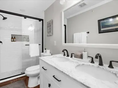 Private full bathroom #1 located in bedroom #1.  Equipped with a full-size walk-in shower, body wash, shampoo, conditioner, Poo Pourri, hand soap, etc. 