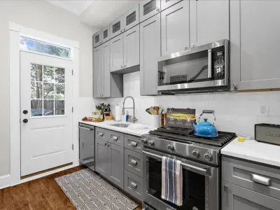 Fully stocked kitchen with stove, oven, full size refrigerator, microwave, tea kettle, and all of the cooking ware and dining ware you need!