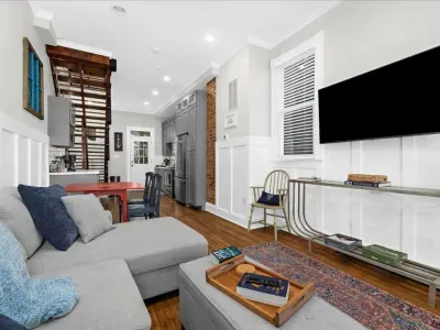 Relax in the comfortable and open living room with a pull-out couch, 55" TV, and dining table with additional seating!