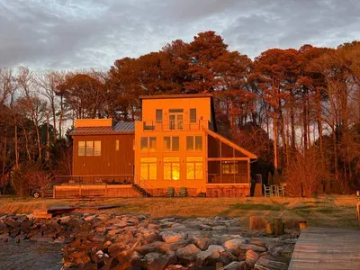 Sunset here doesn’t just sit on the horizon- it reflects across the water and lights up the entire home in a warm, golden glow