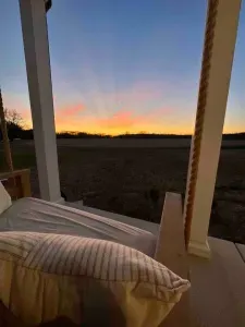 View of sunset from front porch swing
