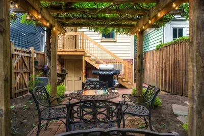 Enjoy a rare fully fenced private backyard with propane grill, outdoor seating, and overhead string lights just steps away from The United States Naval Academy and Downtown Annapolis!